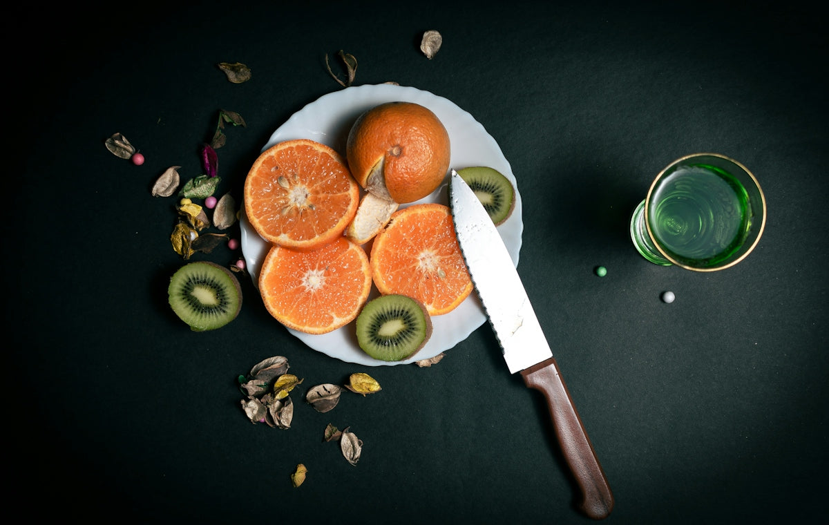 sliced orange fruit on black round plate