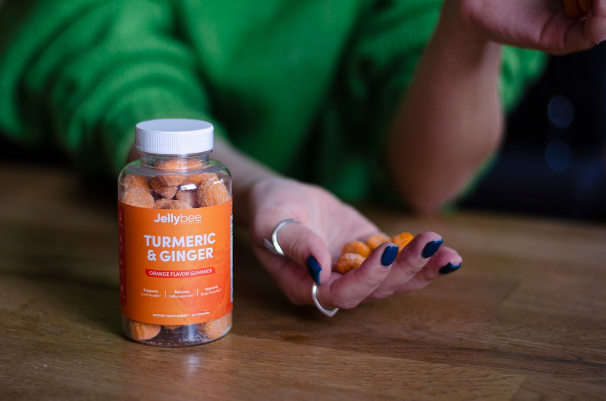 person holding orange labeled bottle