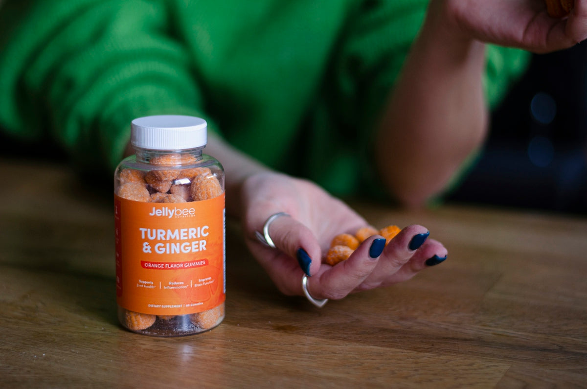 person holding orange labeled bottle